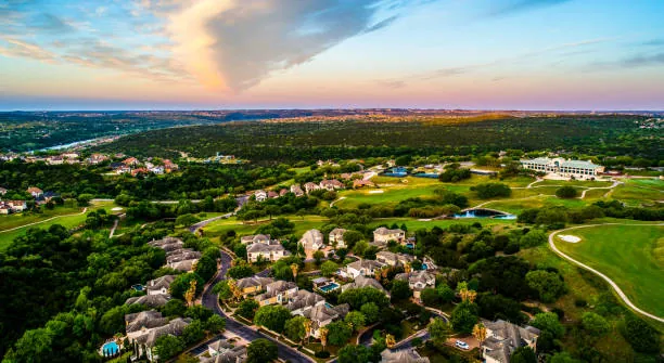 Hill Country sunset over acreage estate homes near the Reagan's Overlook neighborhood of Leander, Texas