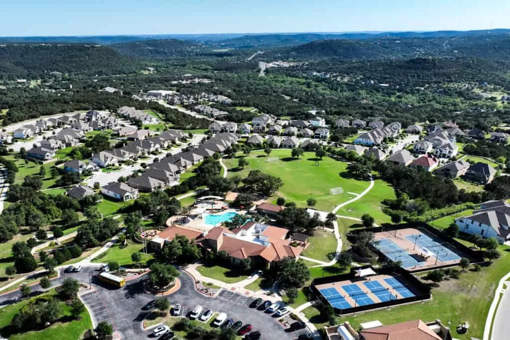 Aerial view of Travisso homes and amenity center in the Leander Hill Country