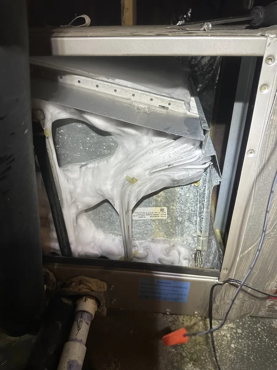 Frozen evaporator coil on an AC system — a common cause of warm air and reduced airflow