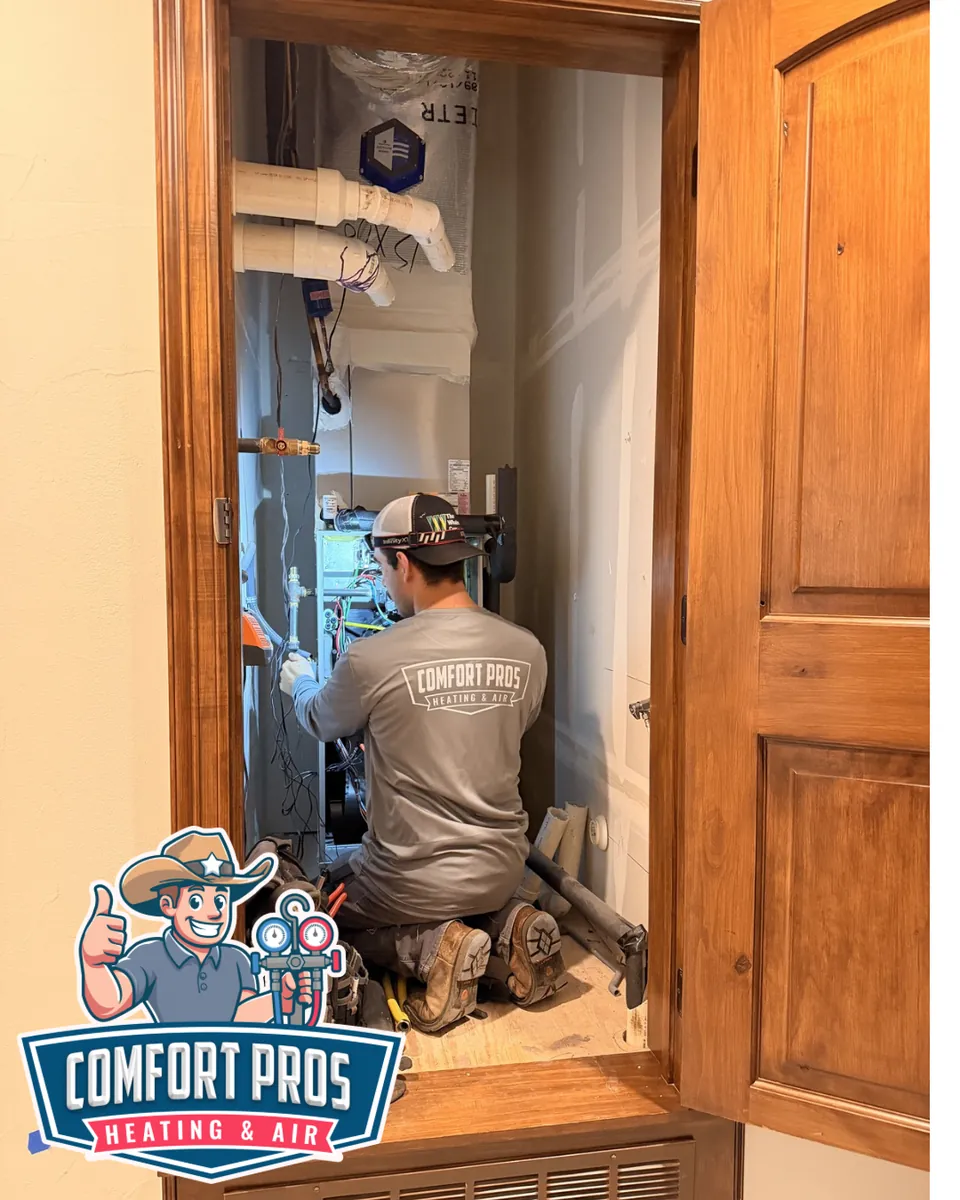 Comfort Pros technician diagnosing an air handler on an emergency AC repair call in Leander, Texas
